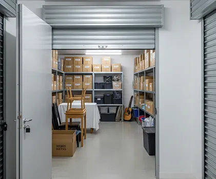 Self-storage unit with neatly organized personal items stored in a secure, clean space